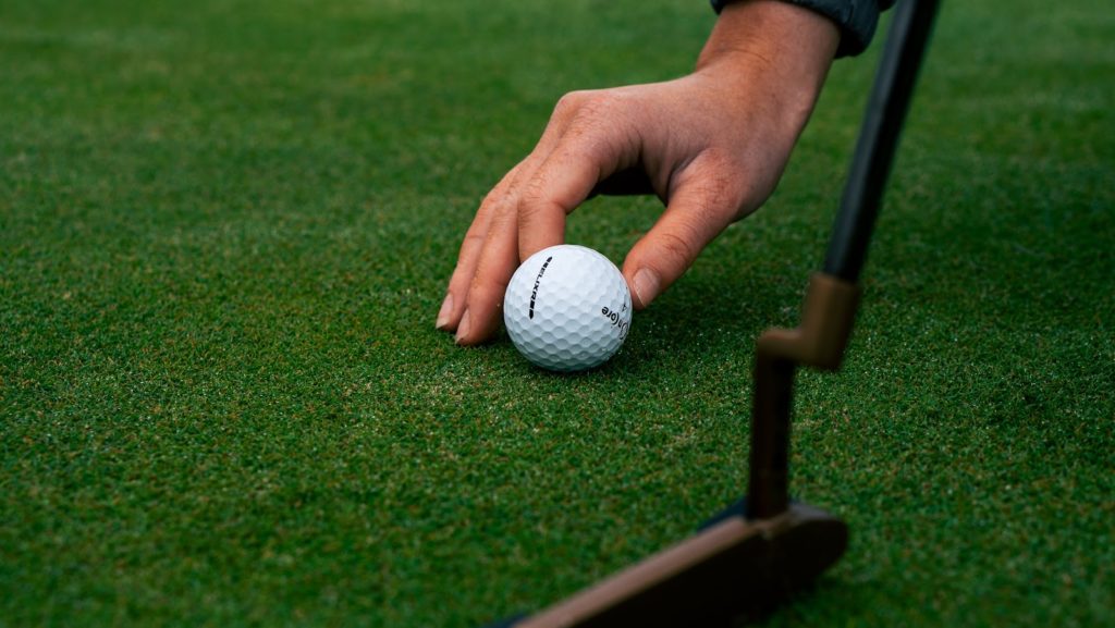 A man setting a golf ball